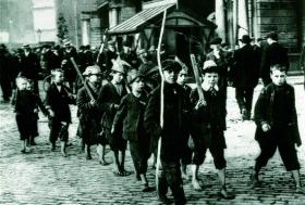 Following the creation of two paramilitary forces—the Ulster Volunteers and the Irish Volunteers—much of Irish society became militarised; young men marched, drilled and prepared for conflict, as did these barefoot Dublin inner-city children. (George Morrison)