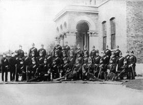 Group of officers photographed outside the officers’ mess, Phoenix Park, Dublin, 1885. Reed (in plumed hat) is seated in the middle of the photograph. (Royal Ulster Constabulary GC Museum)