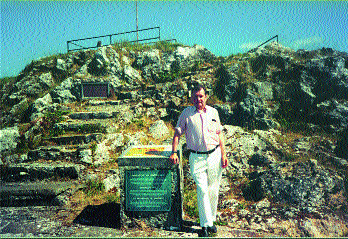 The author beside the plaque unveiled at Ballyneety by President 