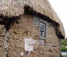 The walls are primarily constructed of mud on rubble stone foundations and show a battered profile.
