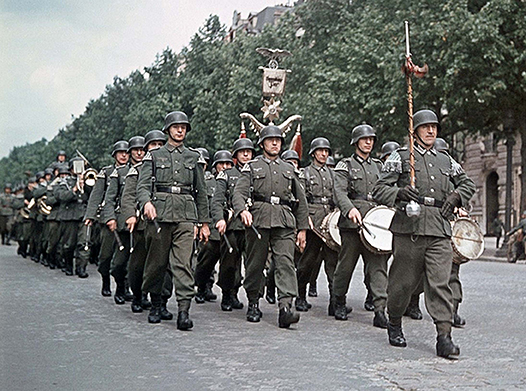 Above: German troops march through Paris, 1940. In the early weeks of the Occupation, a number of Irish people, mostly with British passports but sometimes even with Irish ones, were picked up by the Germans and thrown into internment camps.